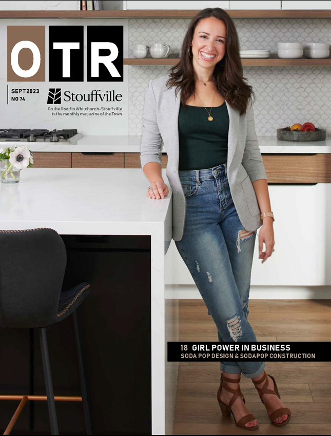 woman leaning on white kitchen island